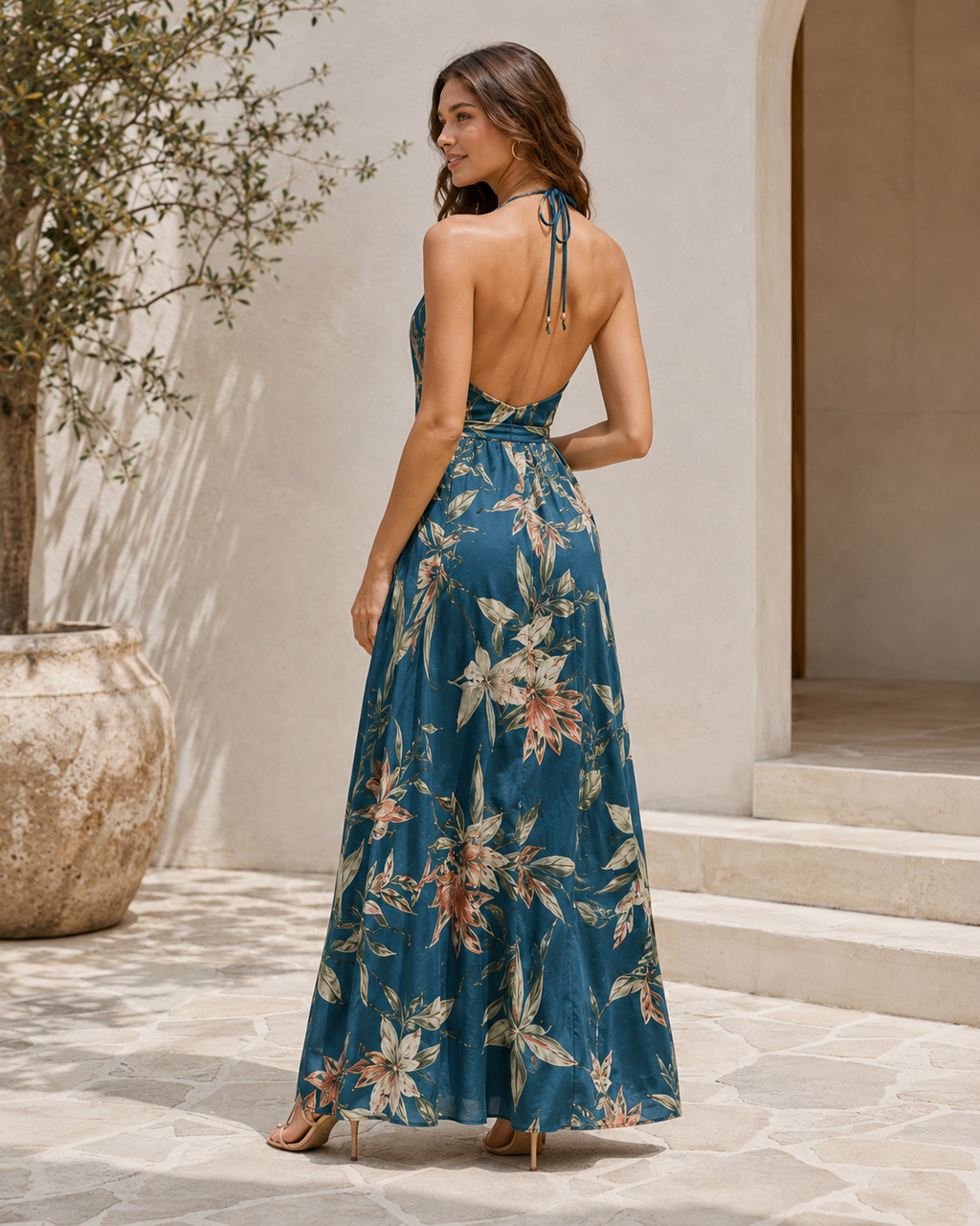 Model showing the open back of the Solstice Garden Halter Maxi Dress outdoors